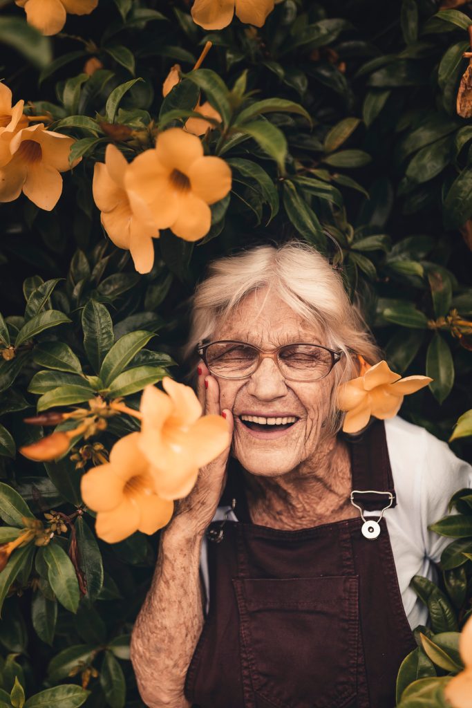 Fit and happy older person amongst the flowers 
